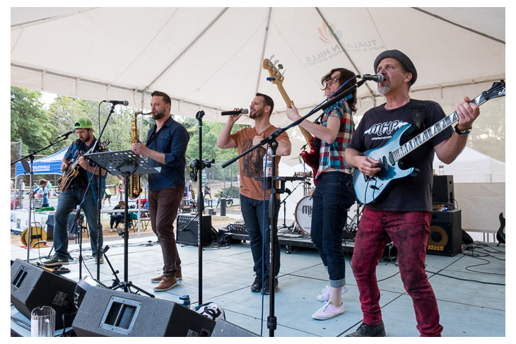 A band performing  at an outdoor venue.