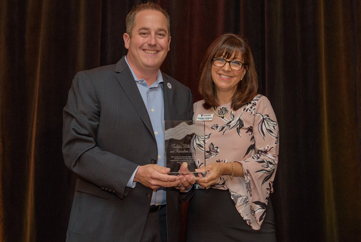 THPRD's Jerry Jones accepts the Employement Award from Georgia Lampros, Edwards Center development director.