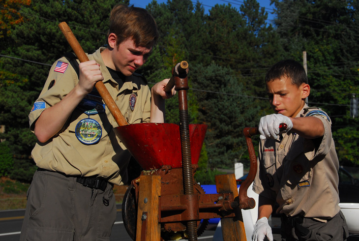 Members of Boy Scout Troupe 208 work antique presses to make exceptional cider.